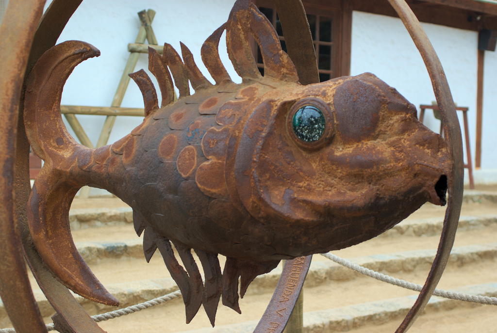 A rust-studded metal sculpture of a fish sits on the steps outside Isla Negra.
