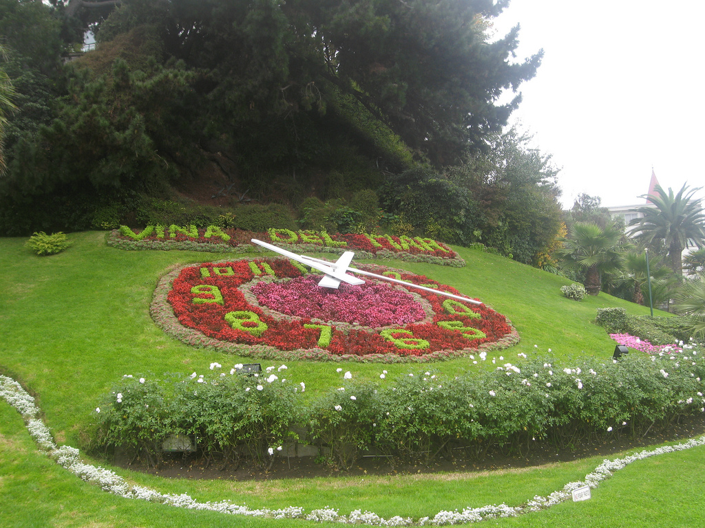 On a gently sloping hill, landscaped flowers form a large working clockface.