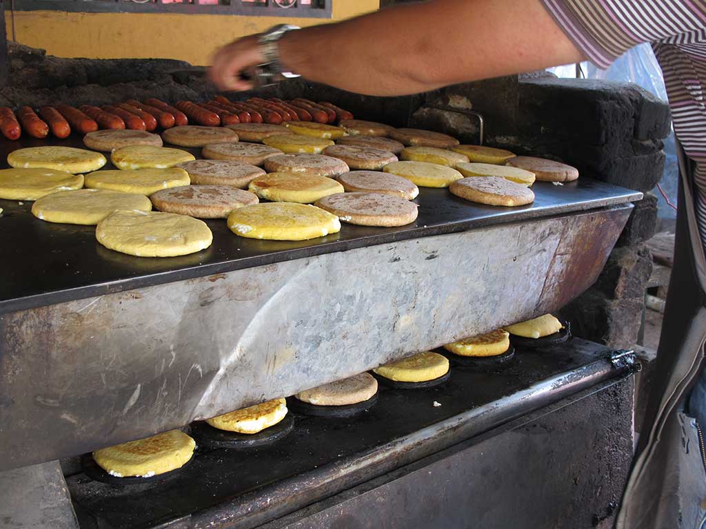 Hot, sweet, and gooey–the arepas of Tinjacá are worth both the calories and the trip. Photo © Andrew Dier.