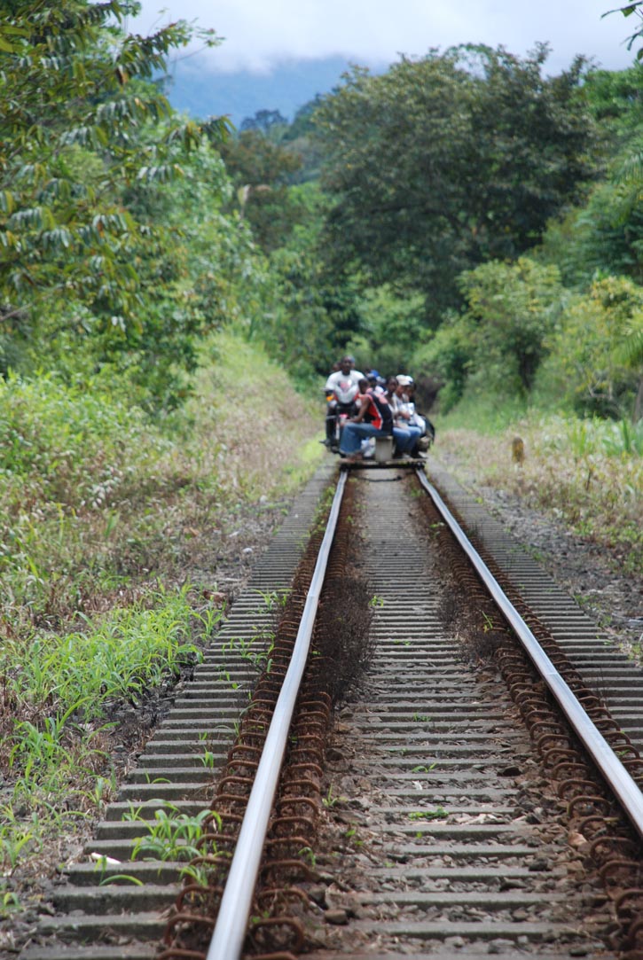 A wooden cart and motorbike ferry passengers on train tracks near San Cipriano, Colombia.