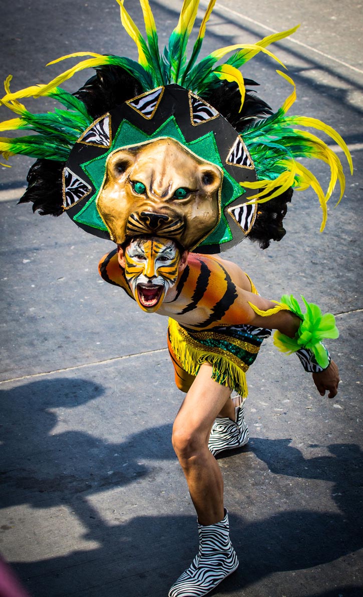A performer in an elaborate cat costume growls at the crowd.