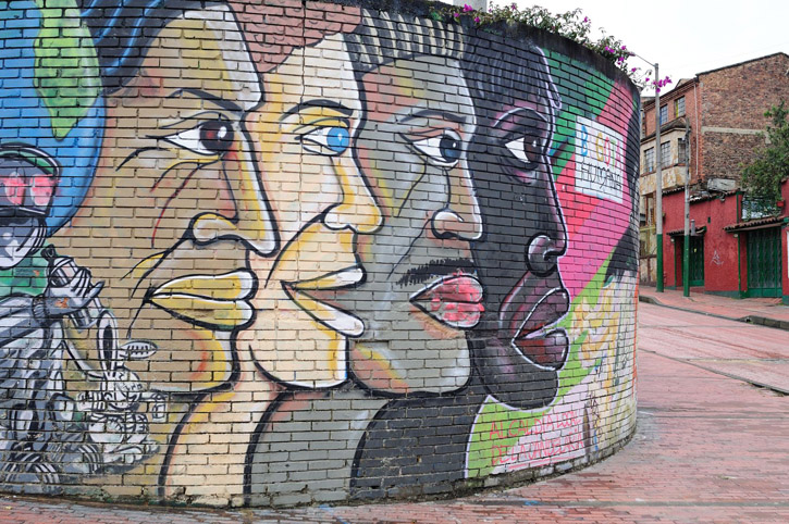 A mural painted on a brick wall illustrates Colombia's multicultural nature.
