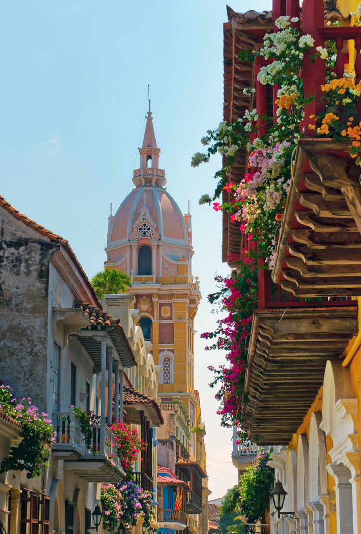 View down a street of a church tower in historic Cartagena, Colombia.