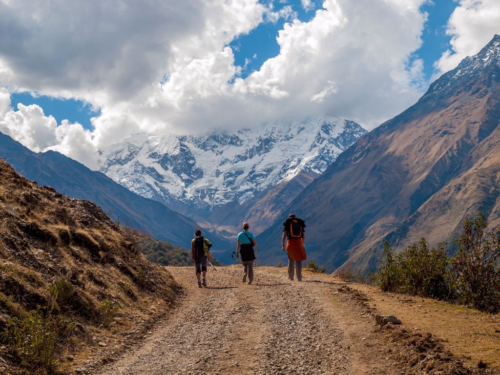 Three travelers trekking in the Andes along the Salcantay route to Machu Pichhu.