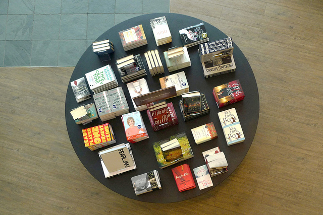 A round black table photographed from above with books displayed.
