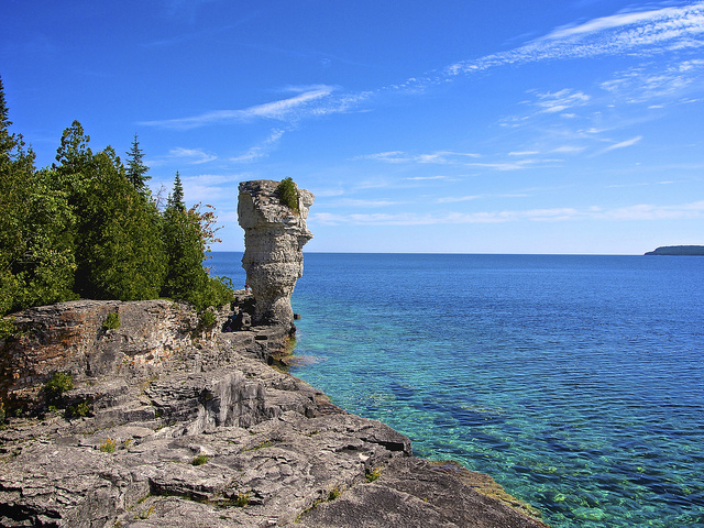 At the edge of the island shore a rock formation that narrows at the bottom resembles a flowerpot.