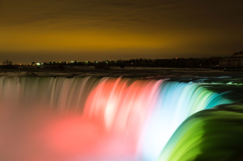 Colored lights on the cascade of Niagara Falls.