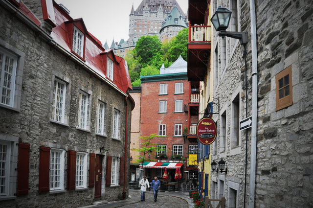 A cobblestoned street curves between the buildings.