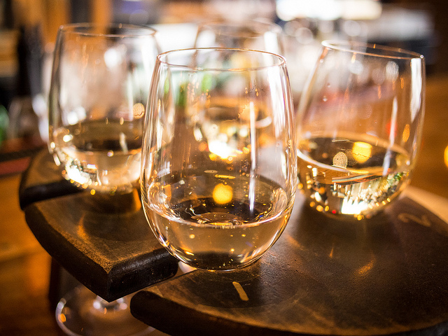 A quartet of white wines hanging in a serving tray.