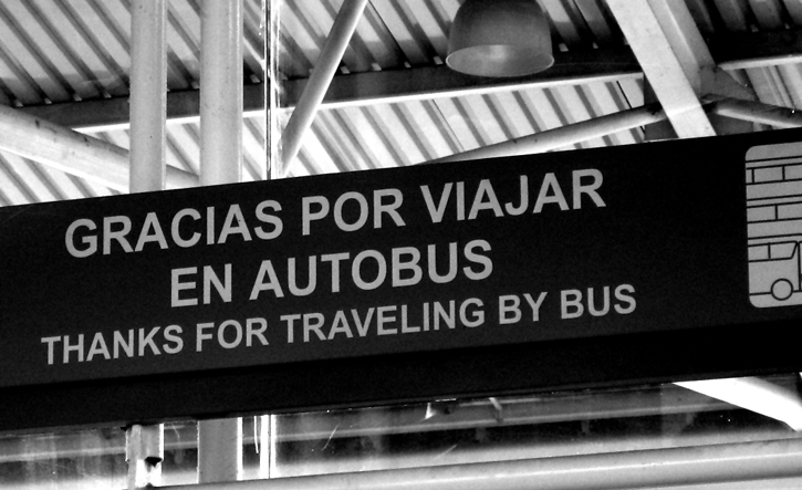 A sign reads Thanks for Traveling By Bus in both spanish and english.