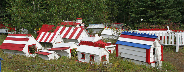 Small Athabascan Indian spirit houses (graves) painted white and red and blue.