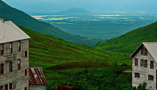 Historic buildings at Independence Mine flank a view down the mountain.