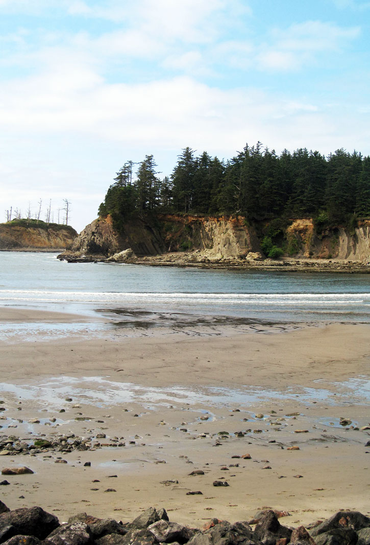 The sandstone cliffs of Sunset Bay State Park shelter the beach, making it a popular destination.