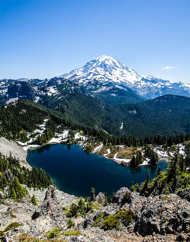 Mount Rainier is an active volcano beloved by outdoor enthusiasts, naturalists, and sightseers.