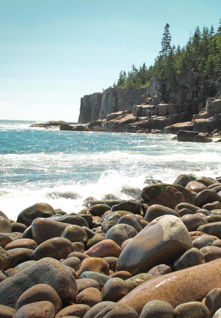 Waves lap against the rocky shoreline of a cove on Mount Desert Isle in Acadia.
