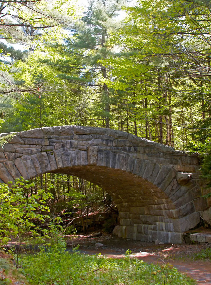 A stone bridge crosses a path in Acadia National Park.