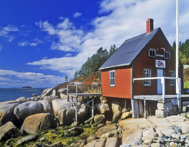 A red single-room lobster house on the edge of Penobscot Bay in Stonington, Maine.