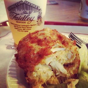 Close-up photo of a crab cake from Faidley, broken open to show huge chunks of crab.