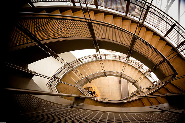 Impressive architecture looking down a spiral staircase.