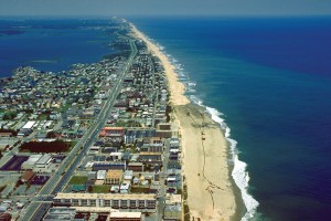 Aerial view of the city stretching out along the narrow Assateague Island, a barrier island with a strip of visible beach.