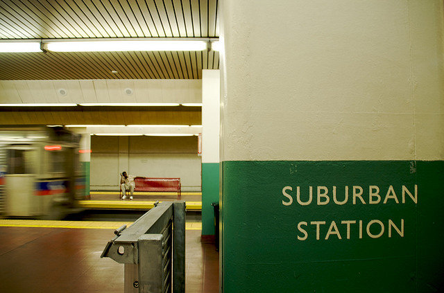 View inside a metro station with the station name painted on the wall.