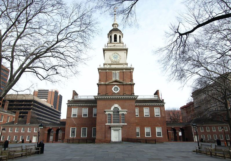 View of Independence Hall, a brick structure with a central steeple.