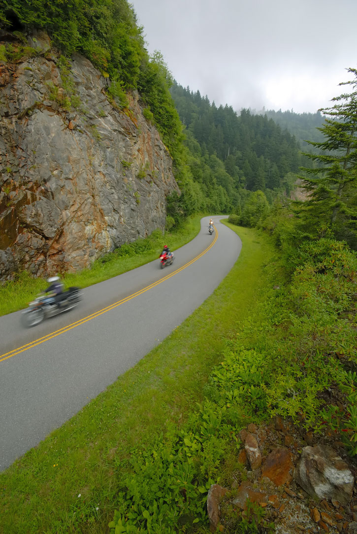 A trio of motorcycles along an S-curve on the Blue Ridge Parkway.