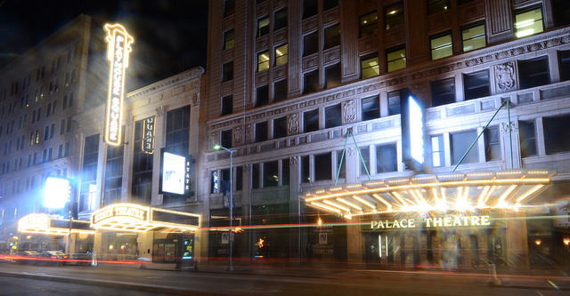 Street view of the neon lights of PlayhouseSquare, slightly blurred from long exposure.