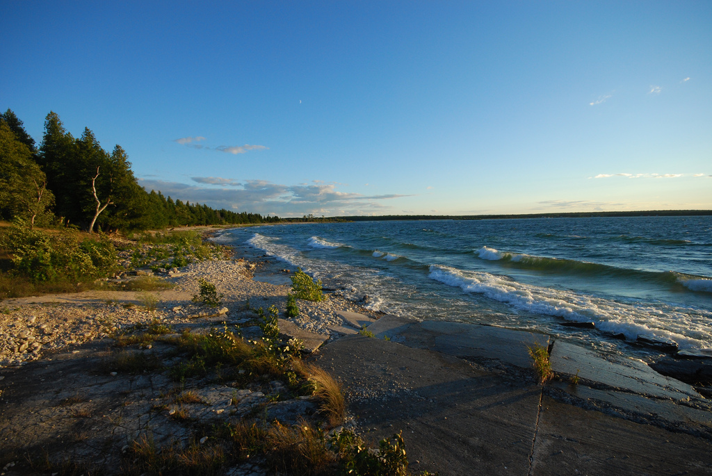 Small waves lap against the sandy shoreline of Wisconsin's Rock Island State Park.