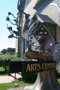A tree shaped sign with Crooked Tree Arts Center written on it.