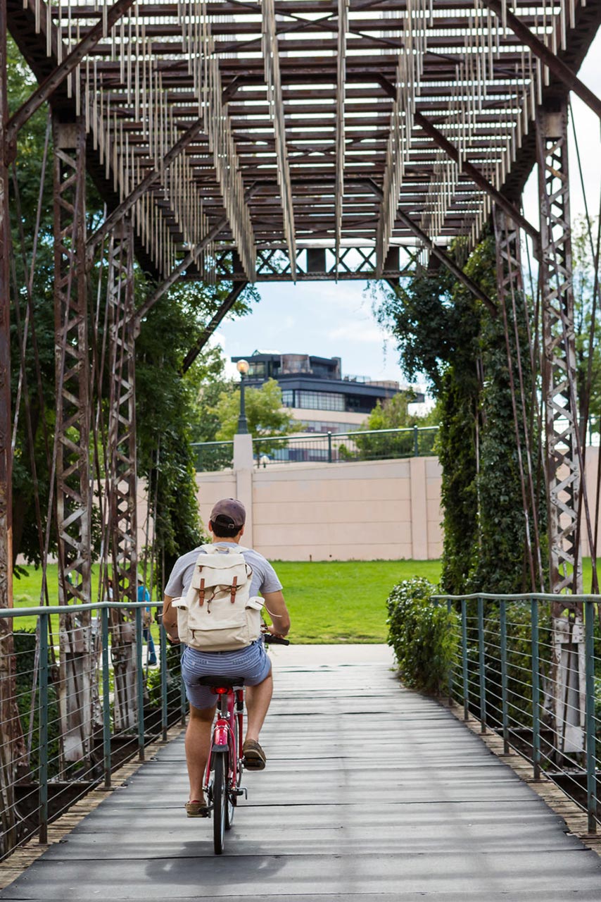 A bicyclist on the Cherry Creek trail in downtown Denver. Photo © 123rf.