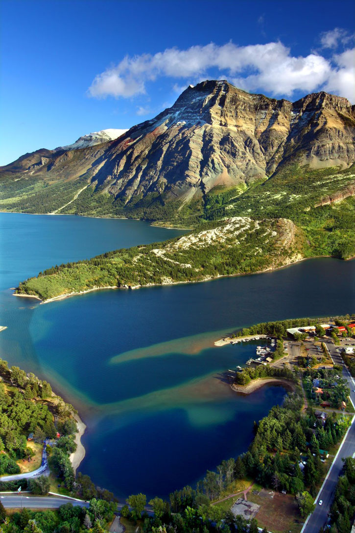 Aerial view over blue waters and mountain peaks of Waterton Lakes National Park in Canada.