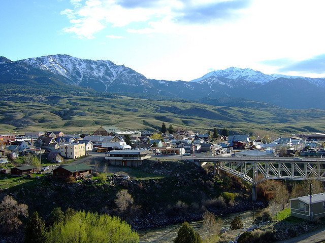 View of the small town of Gardiner, Montana with snow-capped mountains in the distance.