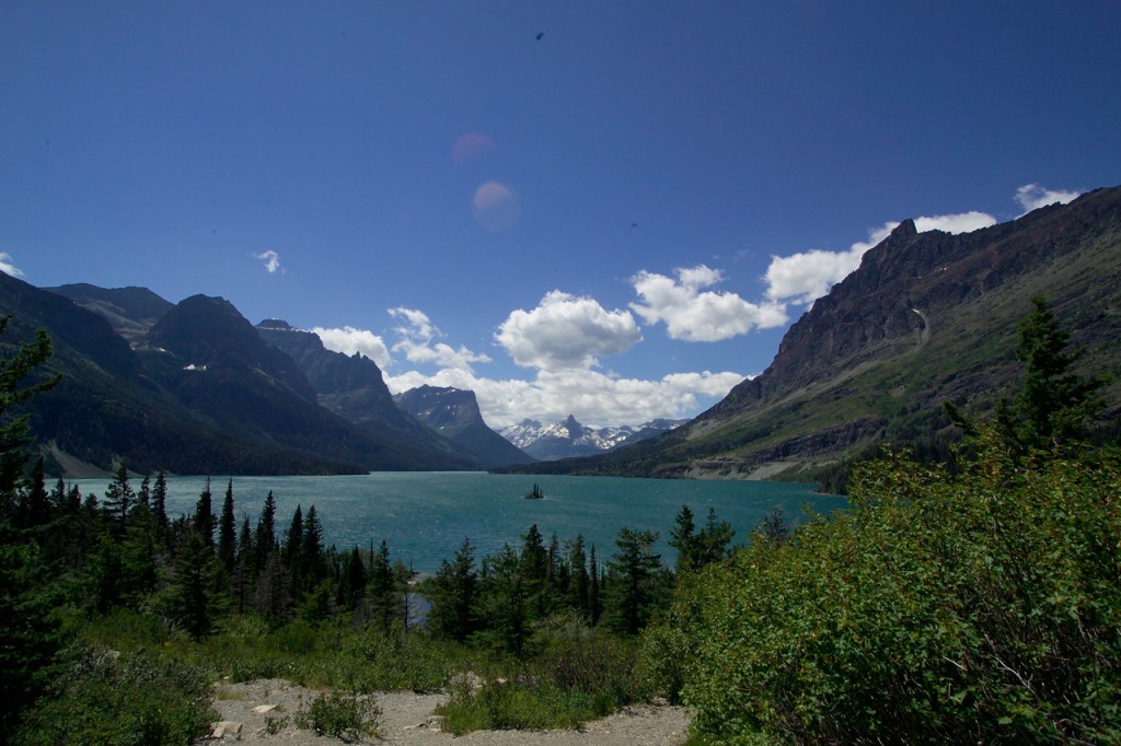 View of a lake with rocky mountainsides rising up sharply from the basin.