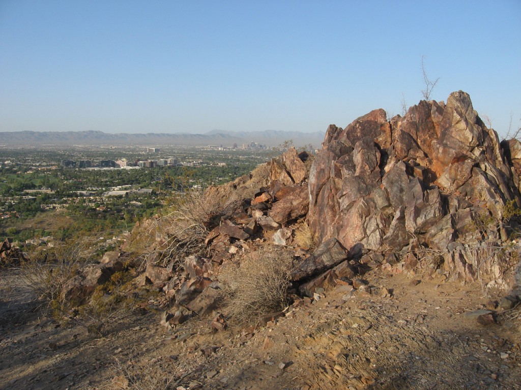 Scenic view taken beside jutting rocks of the surrounding area including midtown Phoenix.
