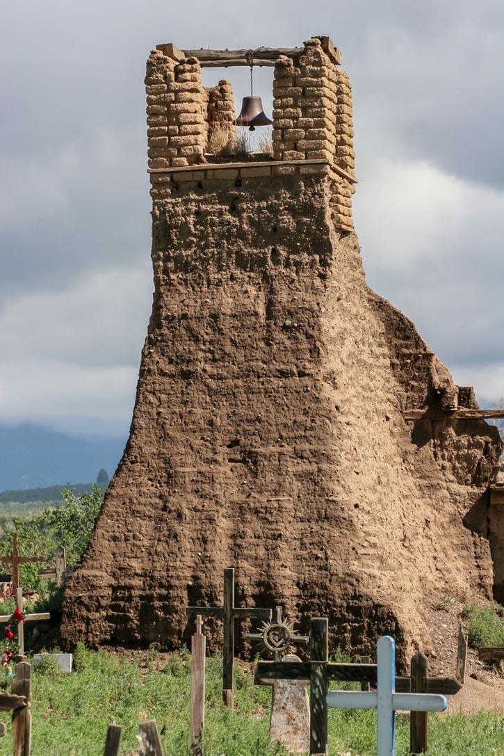 A crumbling church bell tower and wooden crosses mark the site of the Pueblo Revolt of 1680.