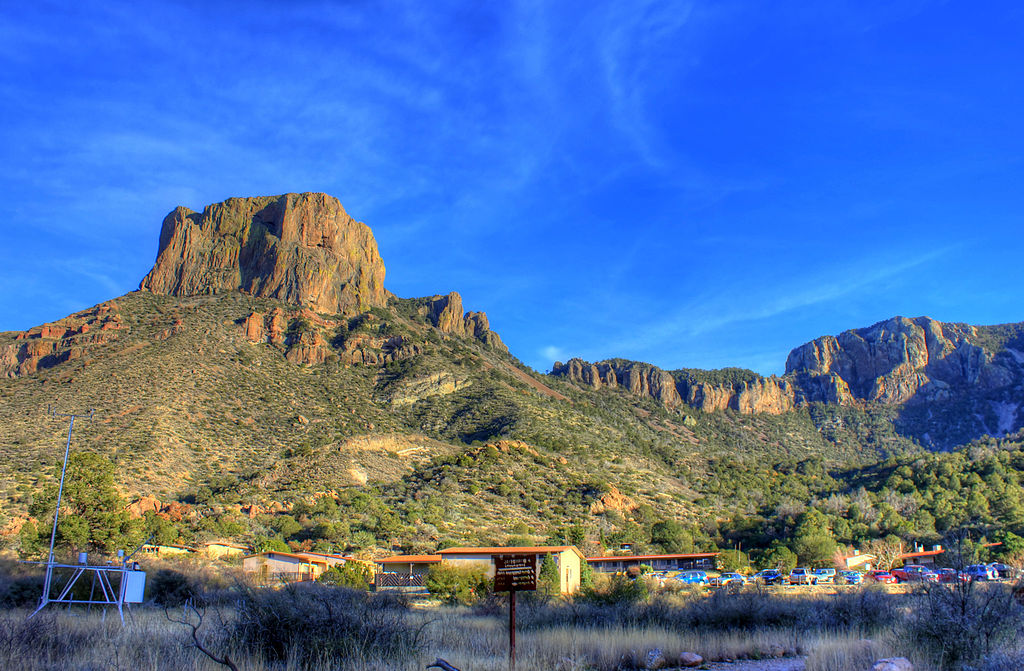 Casa Grande rising above the Chisos Lodge in Big Bend National Park. Photo © Yinan Chen [<a href="http://creativecommons.org/licenses/publicdomain/">Public Domain</a>], <a href="https://commons.wikimedia.org/wiki/File%3AGfp-texas-big-bend-national-park-mountains-by-the-lodge.jpg">via Wikimedia Commons</a>.