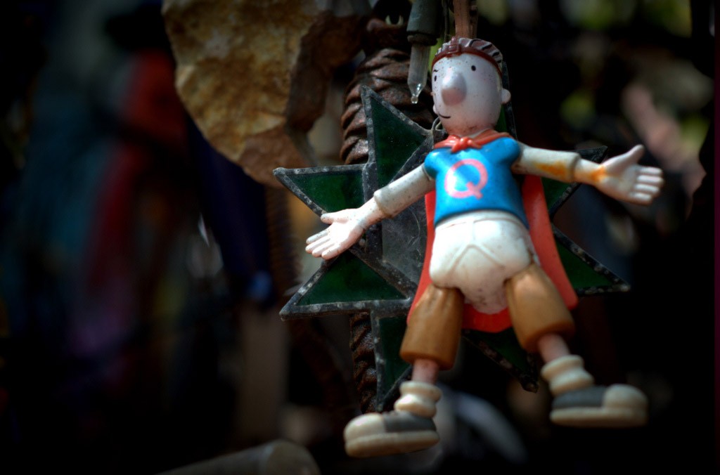 A small figurine hangs beside christmas lights and other junk in Austin's Cathedral of Junk.