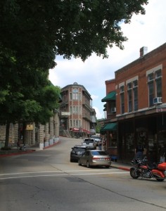 Brick buildings line a quiet, quaint looking street.