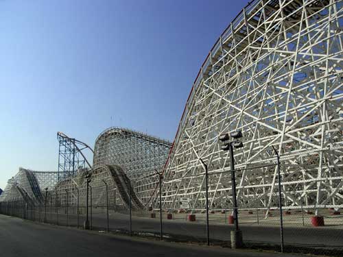 View of the wooden Colossus roller coaster rising up into the sky.