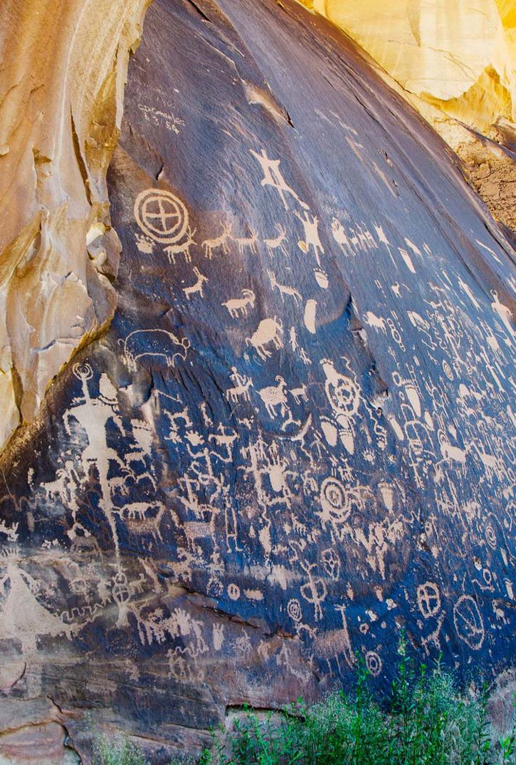 Newspaper Rock petroglyphs on dark stone in Utah's Canyonlands National Park.