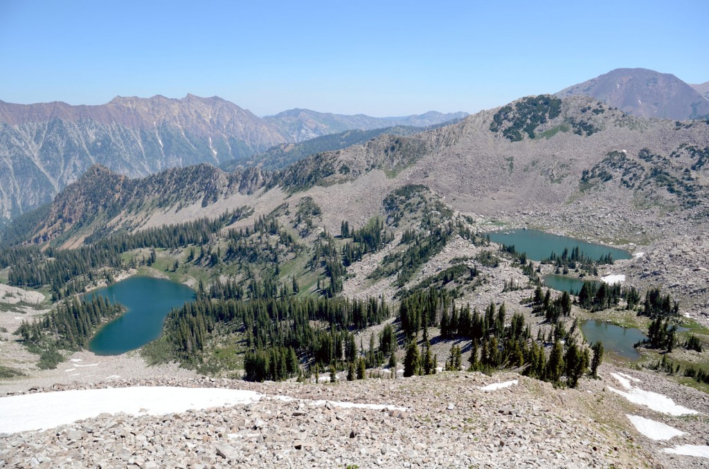 Two lakes are visible ringed with the green of vegitation as seen from on high.