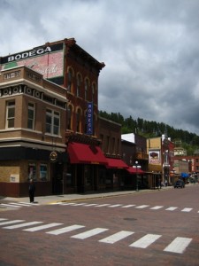 Historic brick buildings line Deadwood's street.