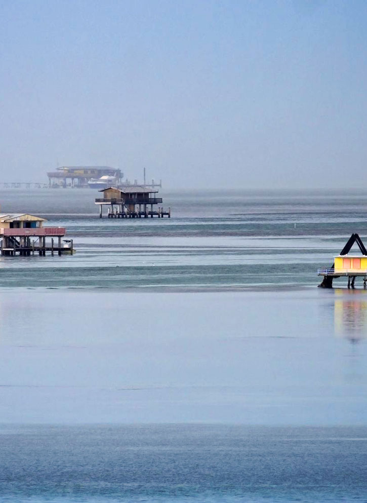 Houses rising above stilts in the waters of Biscayne Bay, Florida.