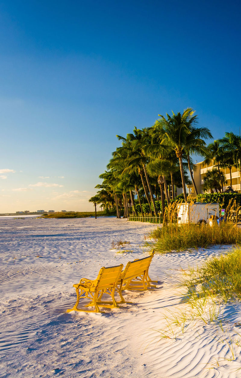A pair of chairs on the white sand beach of Fort Myers, Florida.