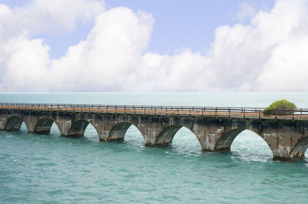 The stone arches of the Seven Mile Bridge stretch out over the aqua ocean.
