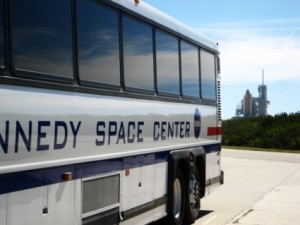 A Kennedy Space Center Tourbus with the launch platform visible in the distance.