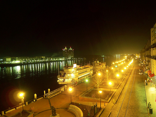 Photo of Savannah, Georgia at night featuring a docked riverboat.