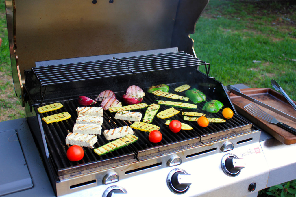 Colorful summer vegetables on an open grill.