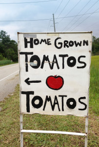 Roadside sign advertising home grown tomatoes.
